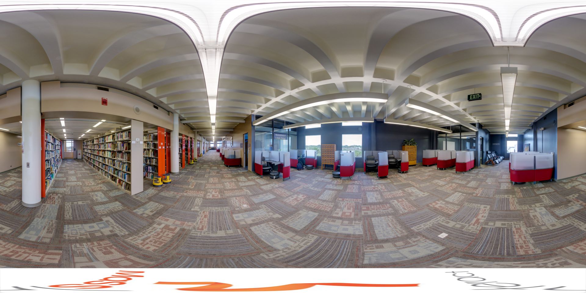 Spacious interior of the Evans Library fourth floor, featuring arched ceilings with modern lighting, rows of bookshelves, and various study pods for students